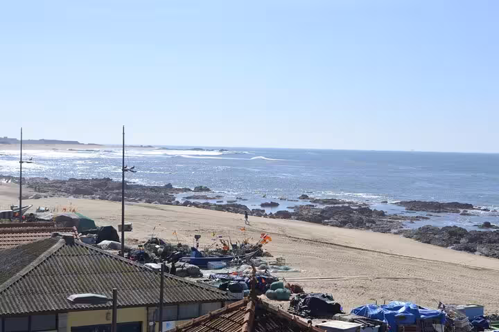 Scenic coastal view of Porto's rocky shoreline and sandy beach, ideal for a private fish tour.