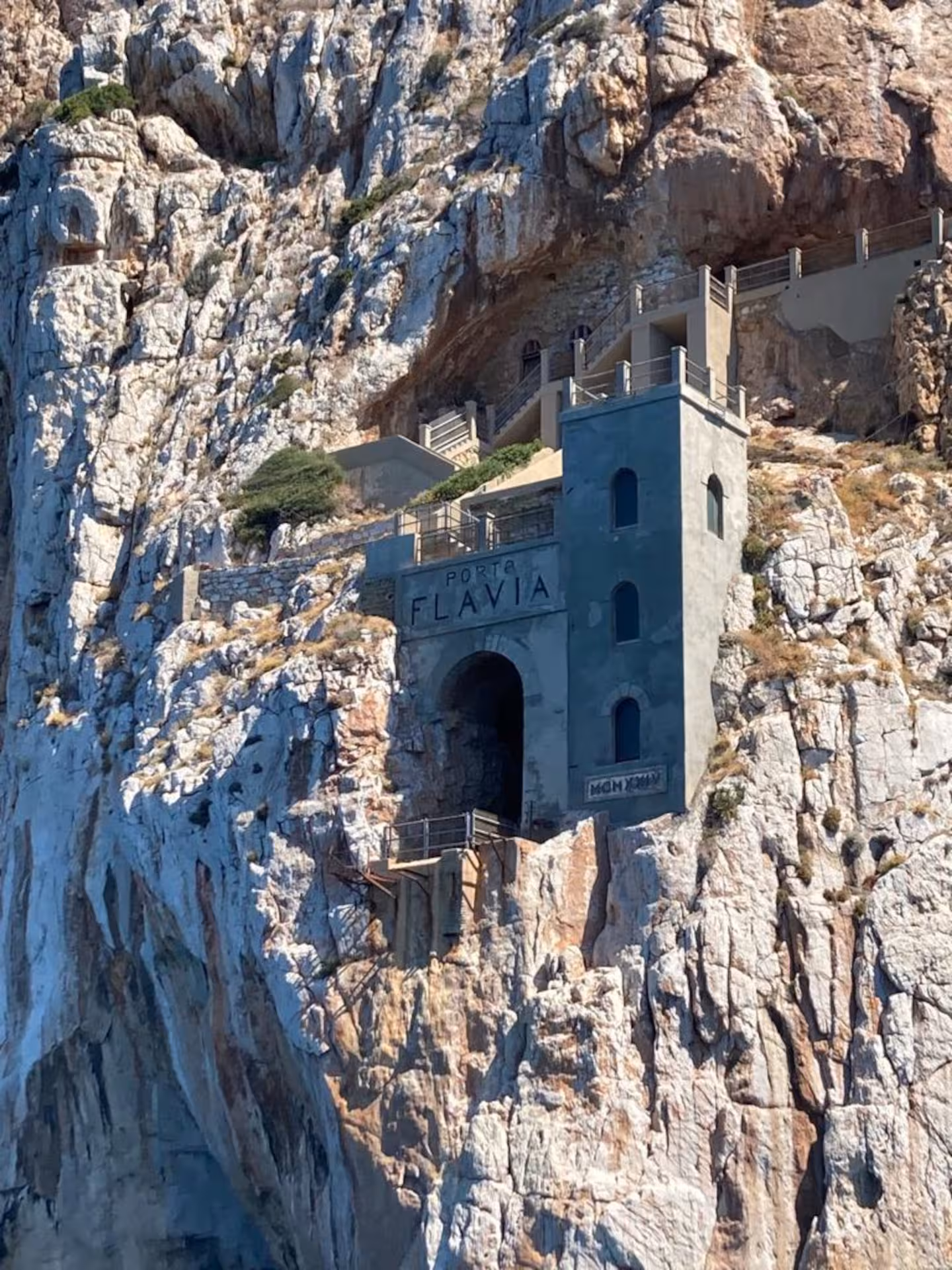 Historic Porto Flavia set into rocky cliffs, a highlight on the Sant'Antioco RIB tour near Masua.