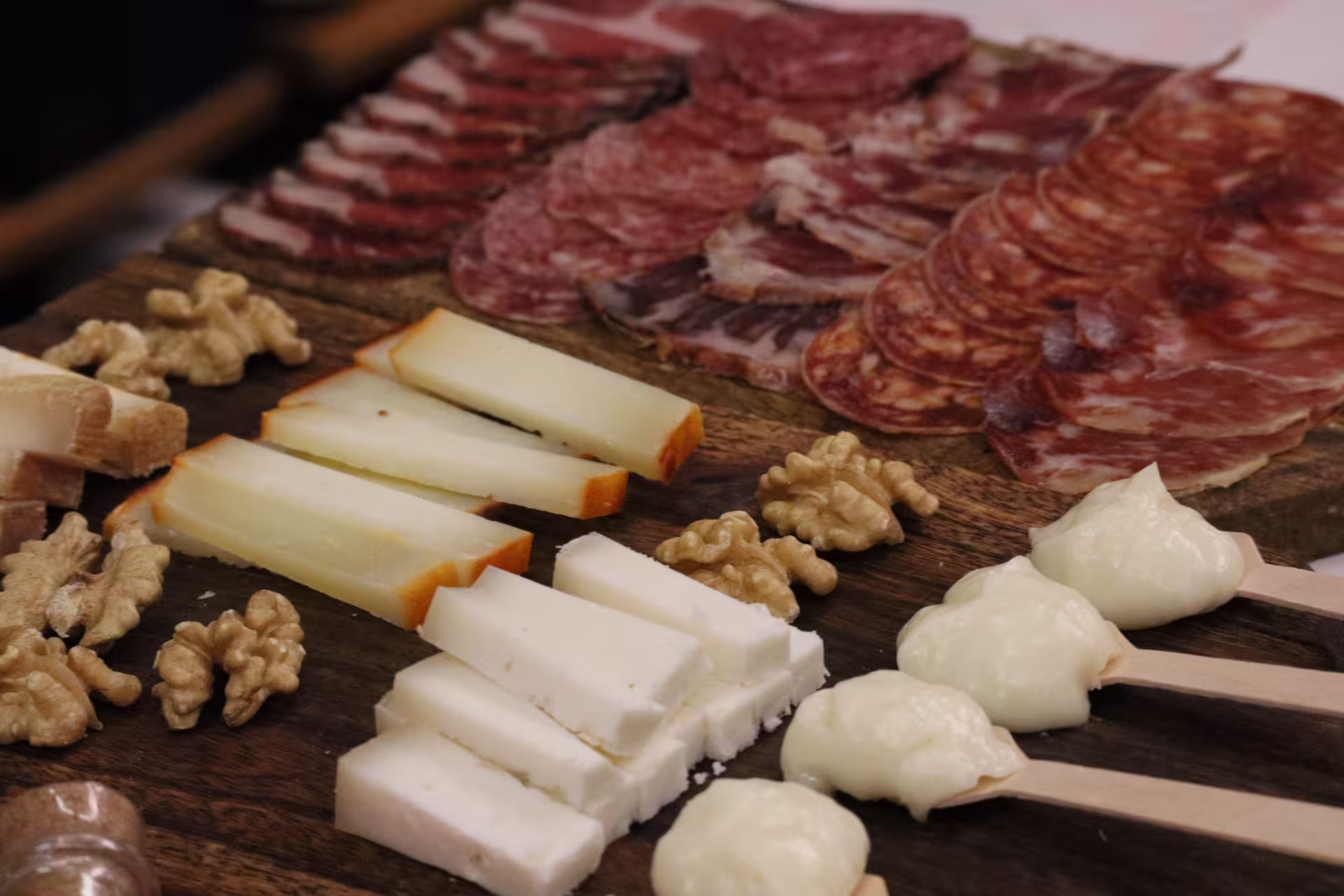 Savor an artisanal cheese and charcuterie board with nuts on a private Porto food tour, highlighting local flavors.