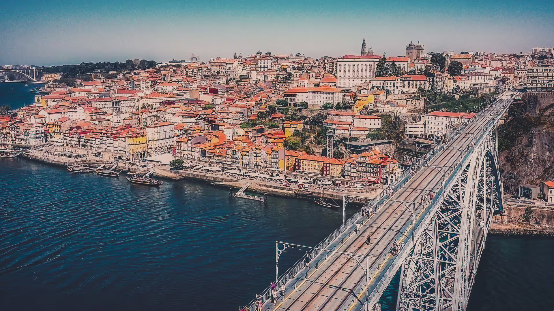 Aerial view of Porto's historic cityscape and iconic Dom Luís I Bridge, perfect for scenic guided tuk tuk tours.