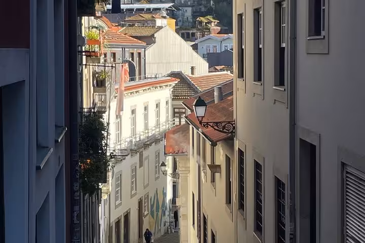 Narrow historic Porto alley with traditional buildings and vintage street lamp on a sunny walking tour