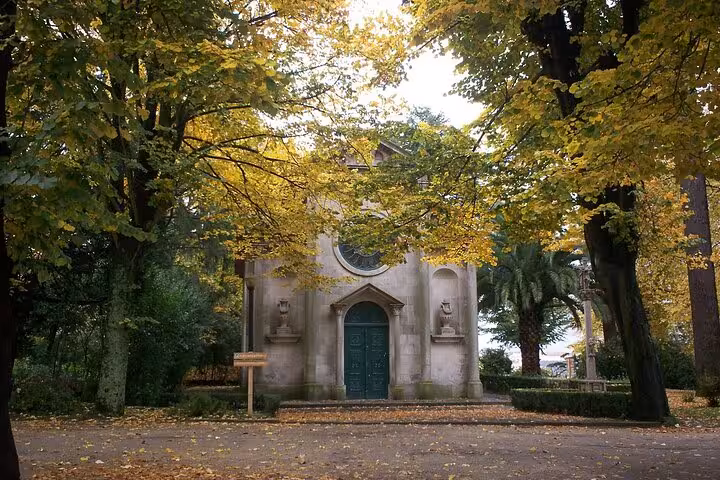 Charming chapel surrounded by autumn foliage in Porto's historic center, a highlight of the local e-bike tour.