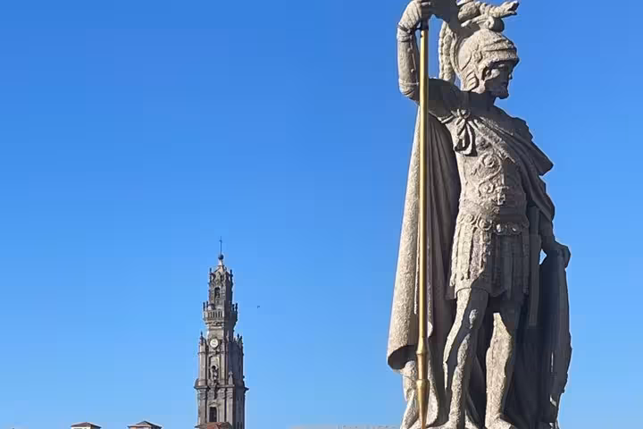 Historic Porto statue with Clerigos Tower landmark under blue sky on a private walking history tour