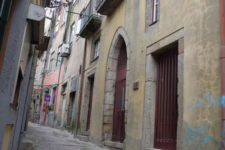 Narrow alleyway in Porto's Jewish Heritage district featuring historic architecture and stone facades.