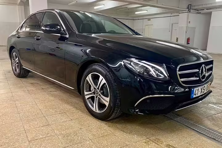 Luxurious black Mercedes-Benz sedan for Porto to Lisbon private journey, offering direct route or customizable stops.