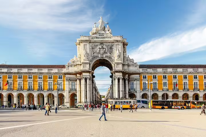 The iconic Arco da Rua Augusta in Lisbon's Praça do Comércio, a must-see landmark on the Porto to Lisbon tour.