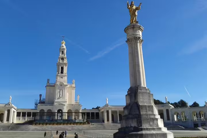 Fatima sanctuary under clear blue skies, a must-see stop on the Porto to Lisbon private journey with customizable routes.