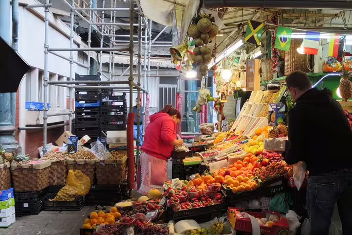 Colorful market scene in Porto showcasing fresh produce, a must-visit on a private tour with local cheese tasting.