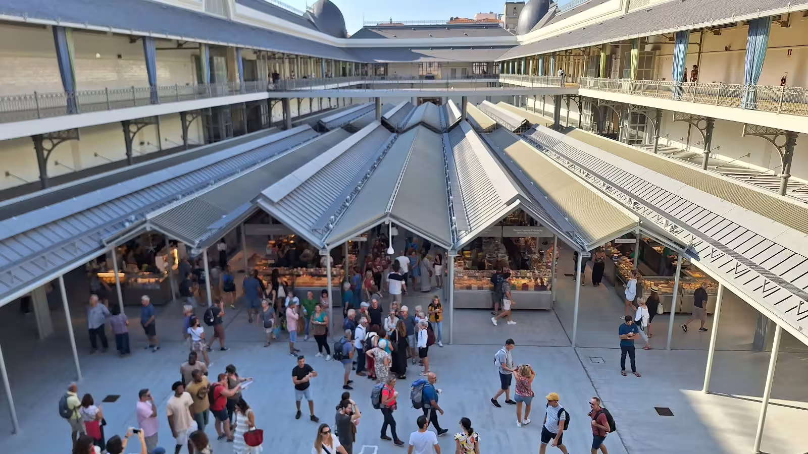 Vibrant scene at Mercado do Bolhão in Porto, bustling with visitors exploring local shops on a guided afternoon tour.