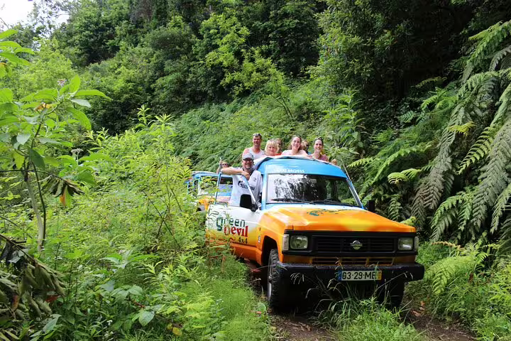 Adventurous tourists enjoy a lush off-road jeep tour in Porto Moniz, exploring Madeira's scenic landscapes with local guides.