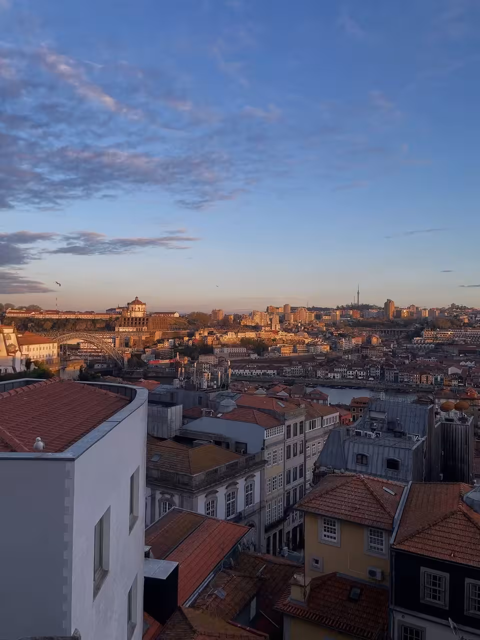 Sunset view over Porto rooftops and the Douro River, ideal for Porto by Night romance and lights tour
