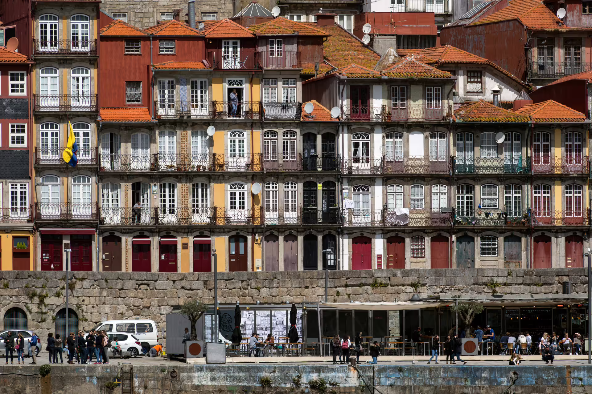 Colorful historic buildings in Porto's old town by the Douro River, showcasing vibrant architecture on a walking tour.