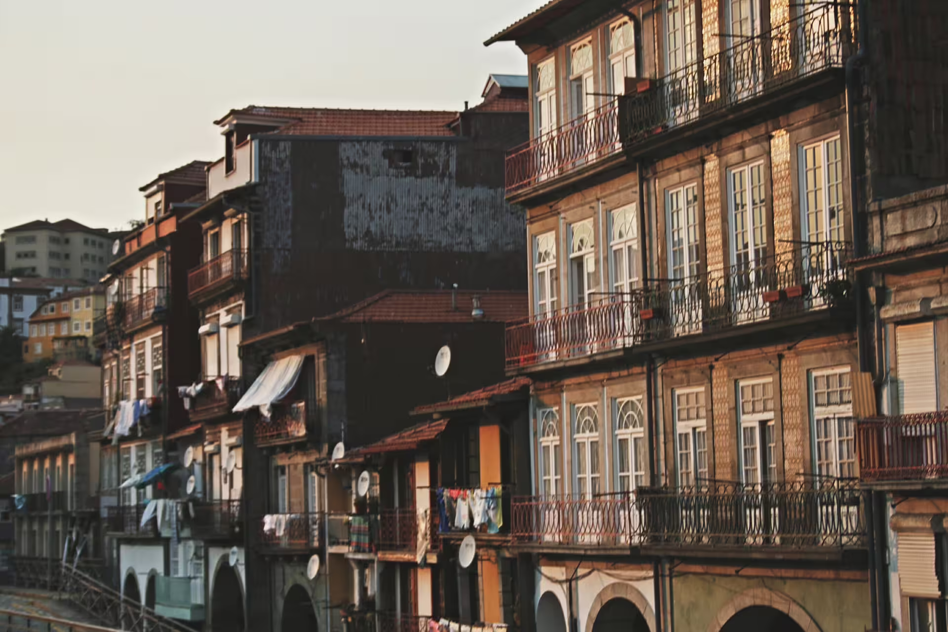 Charming historic buildings in Porto's old town at sunset, perfect for a walking tour and scenic river cruise experience.