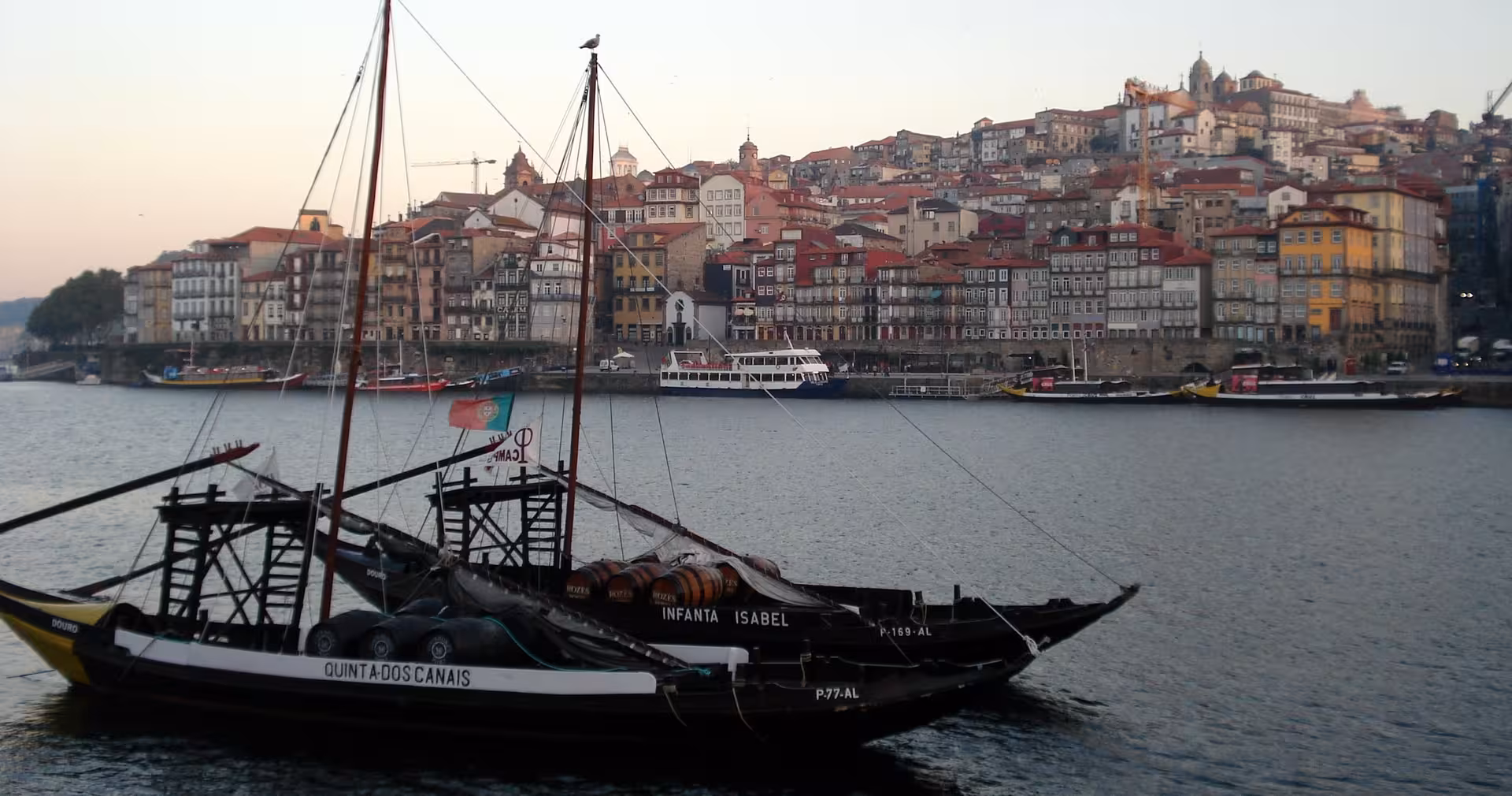 Douro River view in Porto with traditional rabelo boat, scenic backdrop for olive oil tasting tour