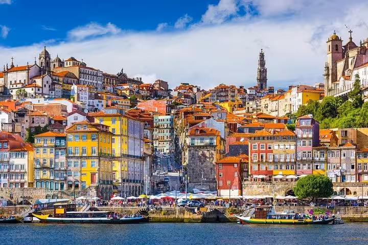 Colorful Ribeira district buildings and boats along the Douro River in Porto, ideal for private 2-day tours.