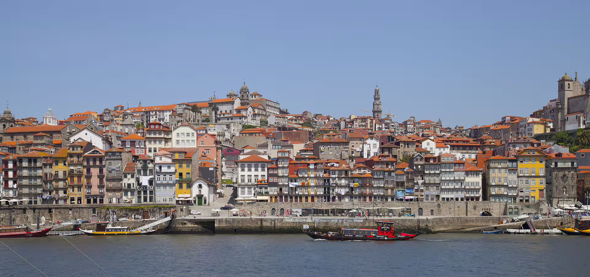 Scenic view of Porto's historic Ribeira district with colorful buildings along the Douro River, perfect for a walking tour.