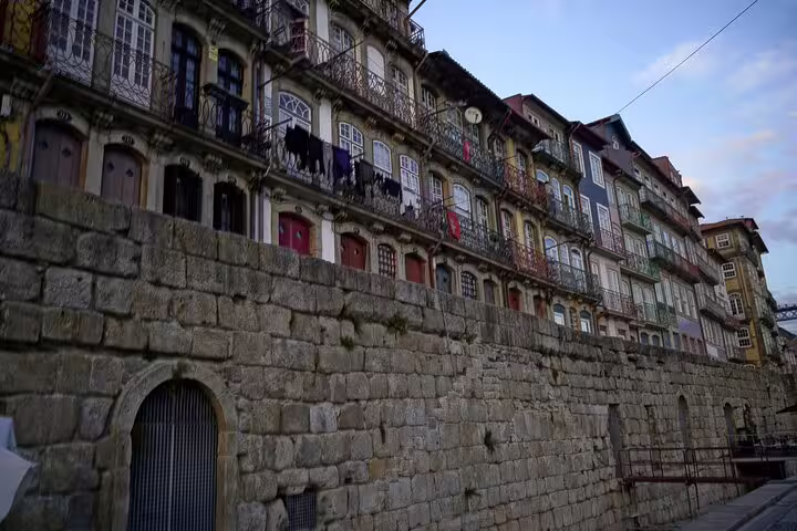 Colorful historic buildings in Porto's Ribeira district, showcasing unique architecture on a private day trip from Lisbon.
