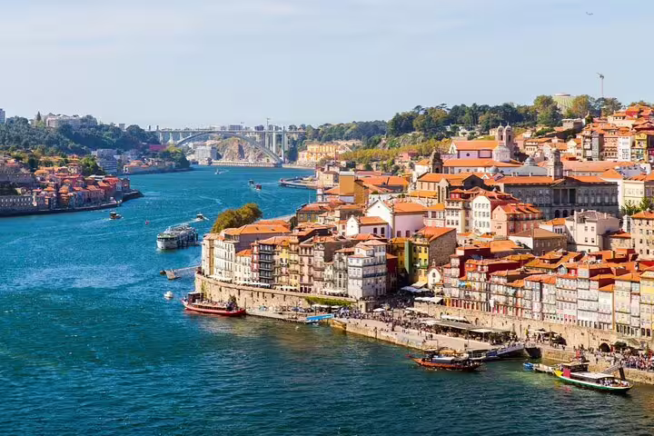 Panoramic view of Porto's colorful riverside buildings with orange rooftops along the Douro River