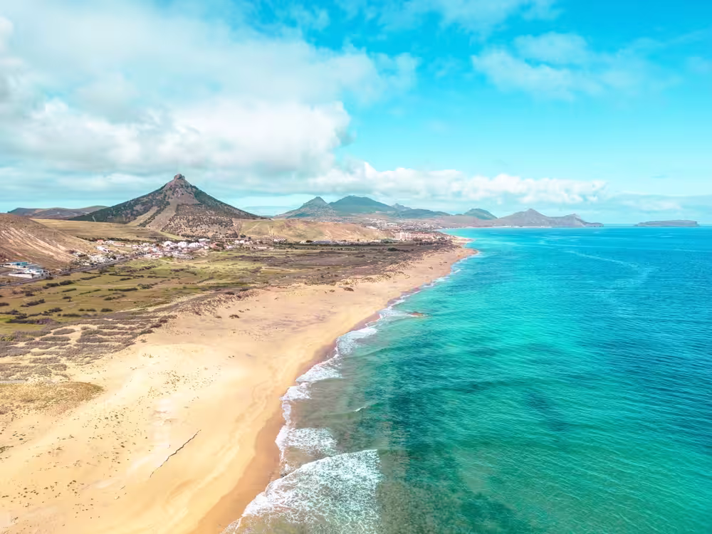 Stunning aerial view of Porto Santo's golden beach and turquoise waters, ideal for a one-day adventure experience.