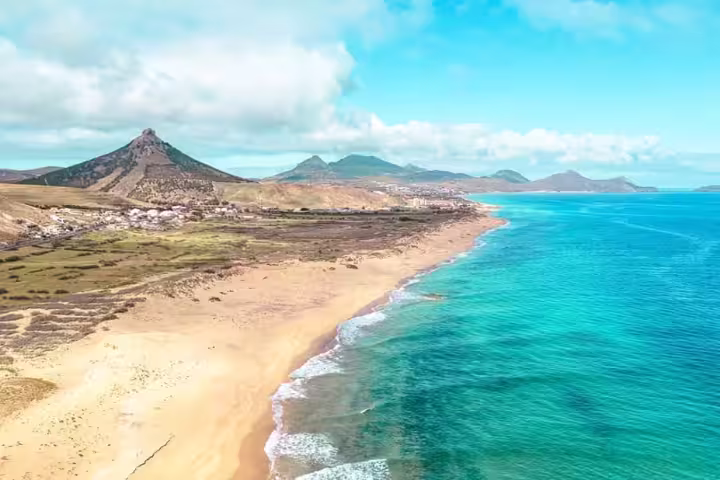 Aerial view of Porto Santo's stunning coastline with golden sands and turquoise waters, perfect for a 1-day land exploration.