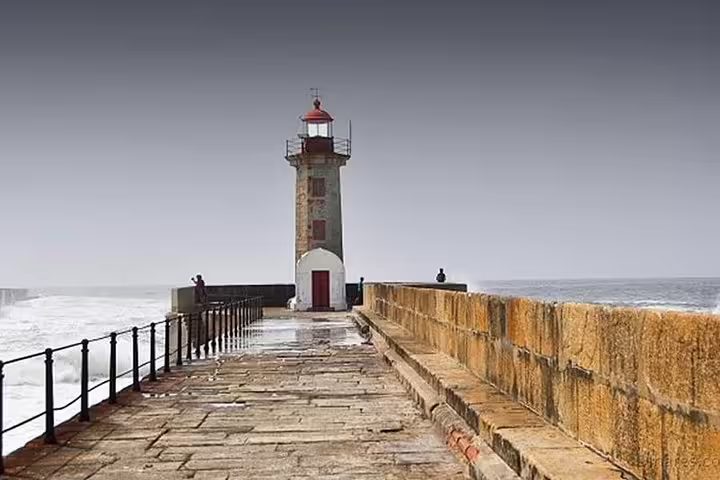 Explore Porto's iconic lighthouse on the Atlantic coast, a scenic highlight of the Six Bridges Cruise tour.