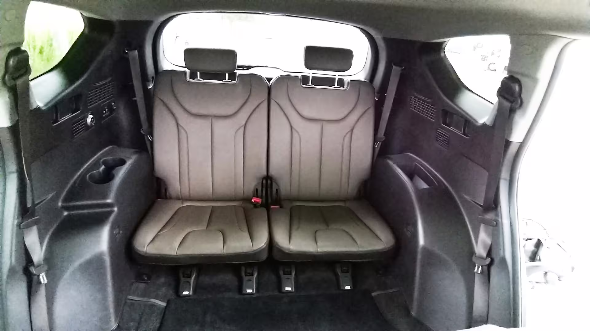 Rear seating area of private transfer car from Porto to Tomar, highlighting ample legroom and modern design.
