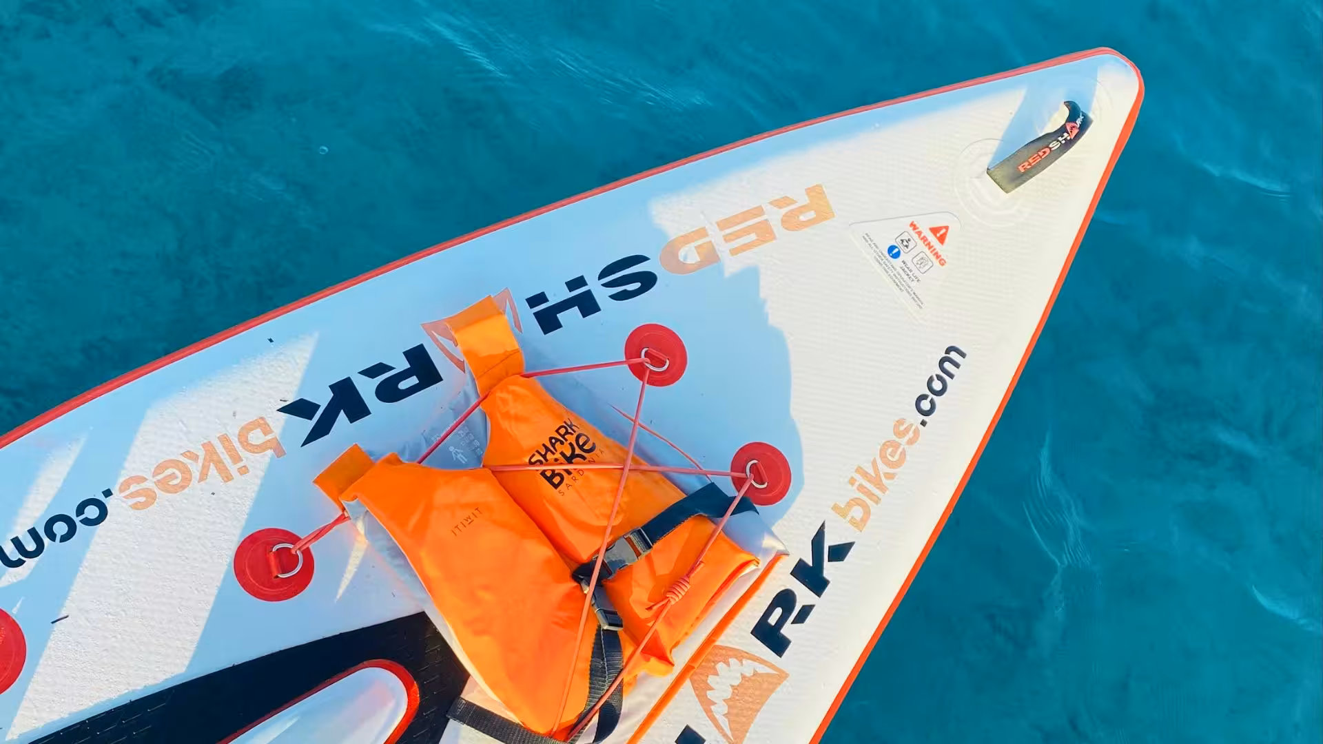 Close-up of a water bike with an orange life vest, highlighting equipment quality for Porto Torres rentals.
