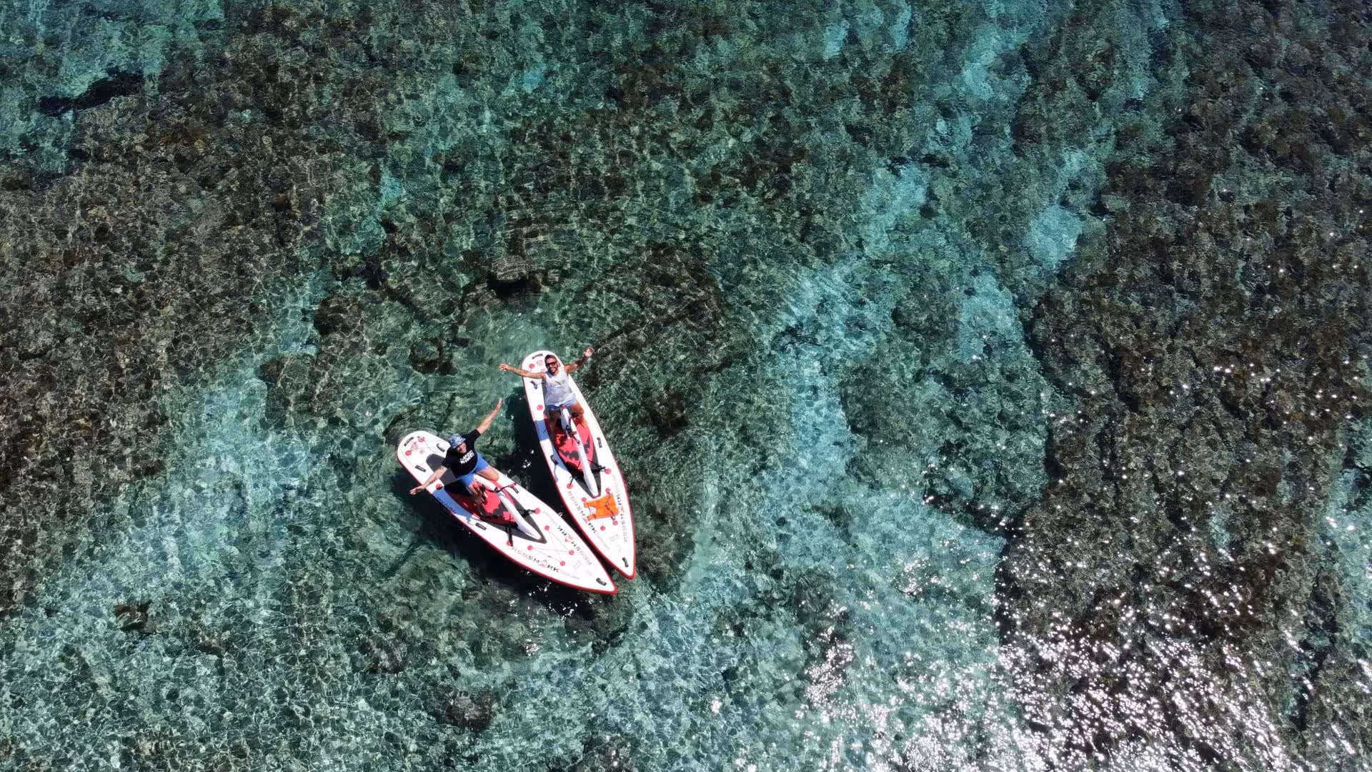 Aerial view of two water bikes on crystal-clear Porto Torres waters, highlighting a unique coastal tour experience.