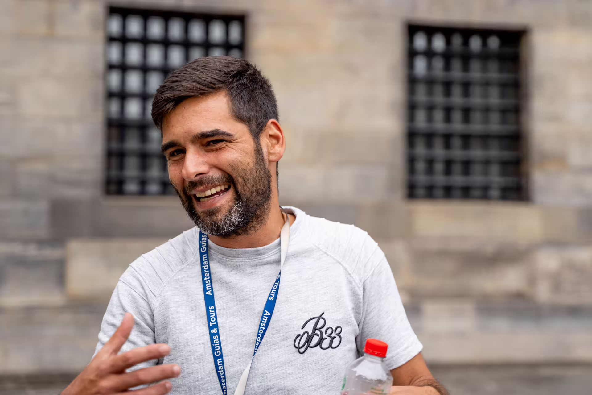 Smiling tour guide in Porto engaging with a small group, offering an unforgettable walking tour experience in the city's historic center.