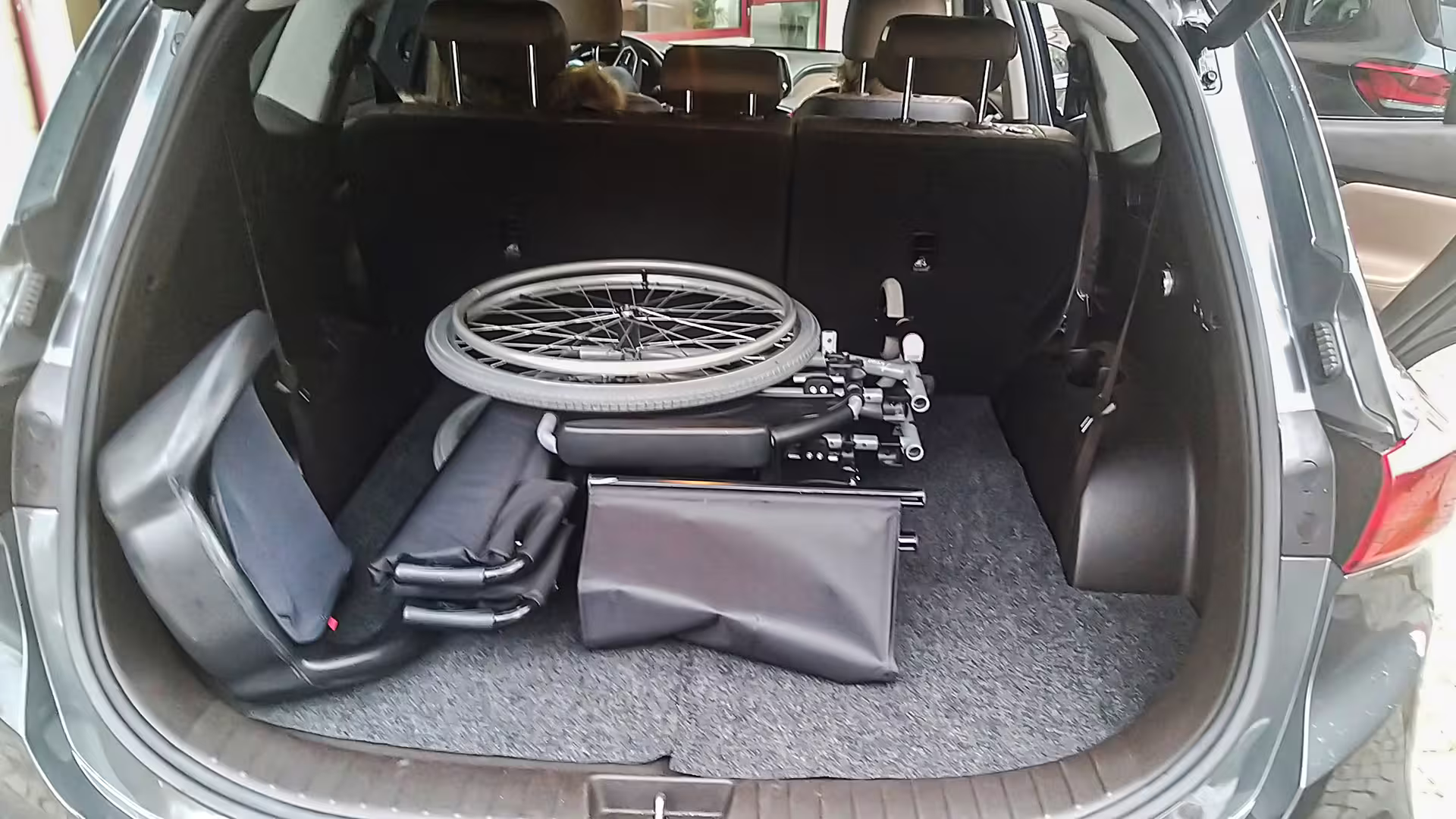 Spacious car trunk with folded wheelchair, ideal for Porto to Vila Real private transfer service.