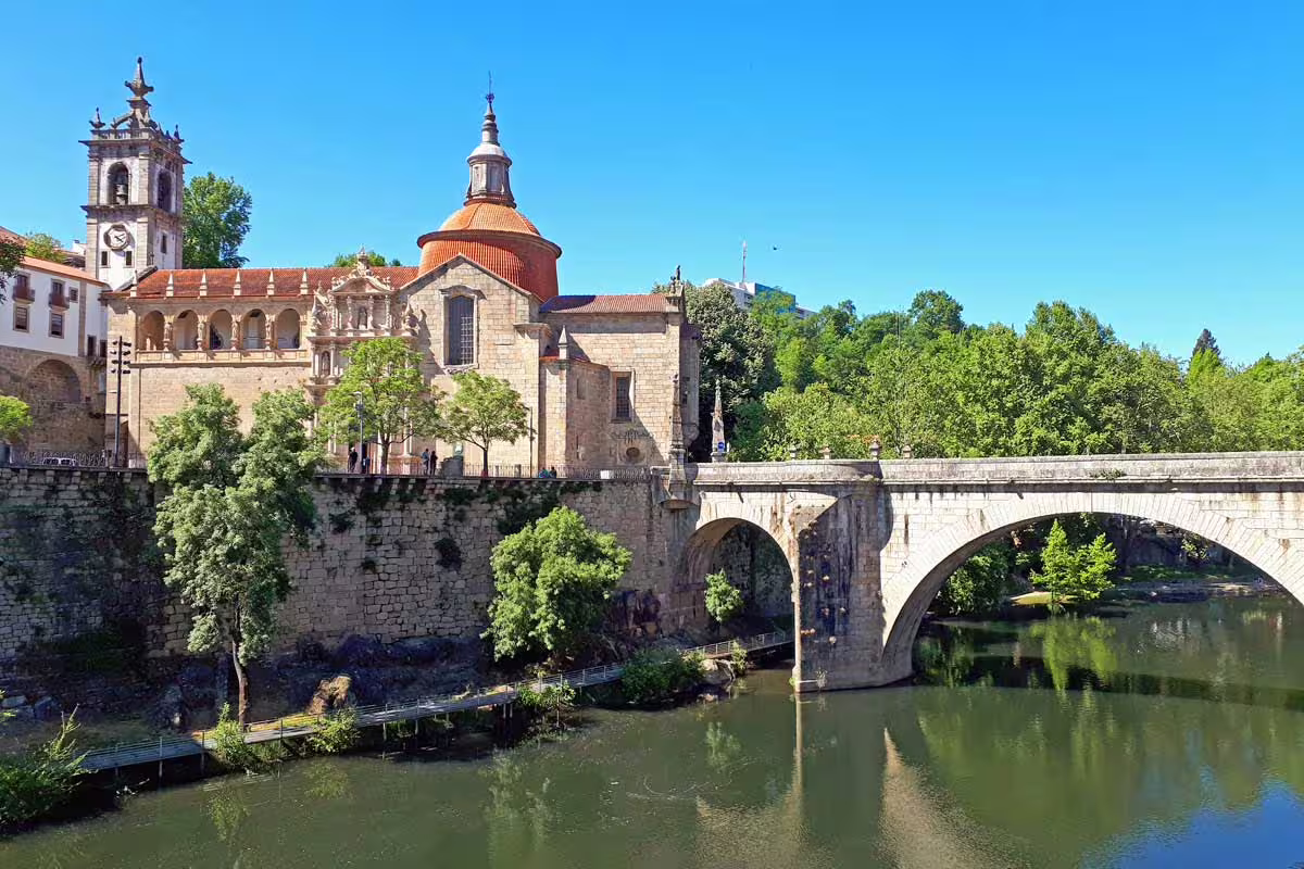 Historic bridge and church in Amarante, scenic view included in the Porto to Vila Real private car transfer.
