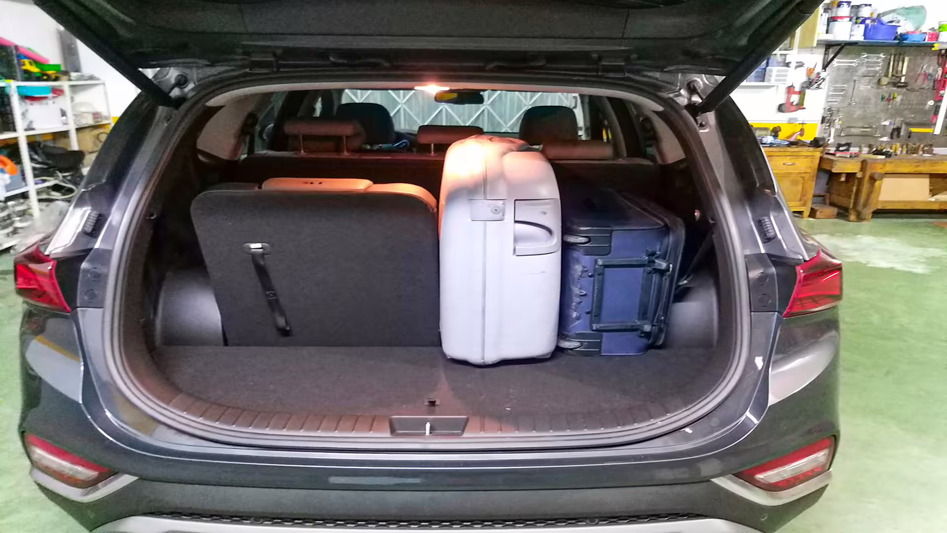Car trunk with two large suitcases, highlighting luggage capacity for private transfer from Porto to Vila Real.