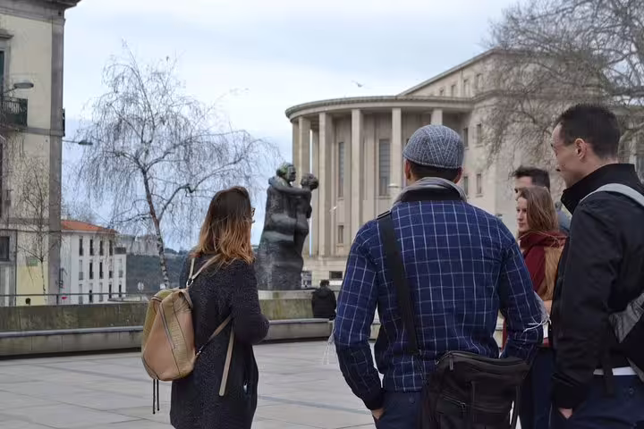 Tour group listens to guide near the iconic Casa da Música, a key highlight of Porto's walking tour experience.