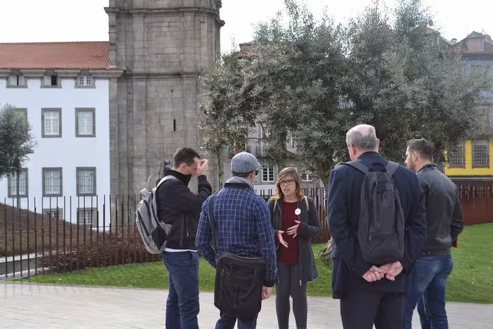 Tour guide leading a group in front of the historic Clérigos Tower in Porto, perfect for an immersive walking tour.