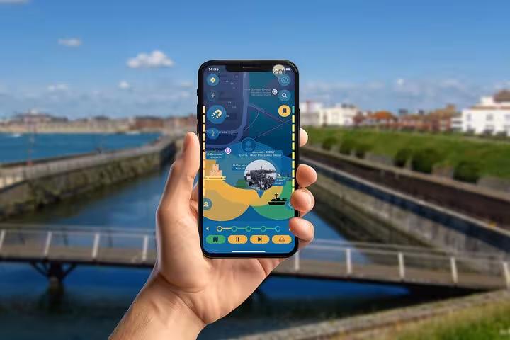 Self-guided Portsmouth smartphone tour app showing interactive coastal map near scenic waterfront promenade