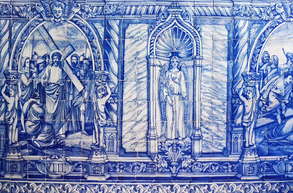 Blue azulejo tiles depicting historic religious scenes, showcasing Portugal's rich cultural heritage and traditional artistry.