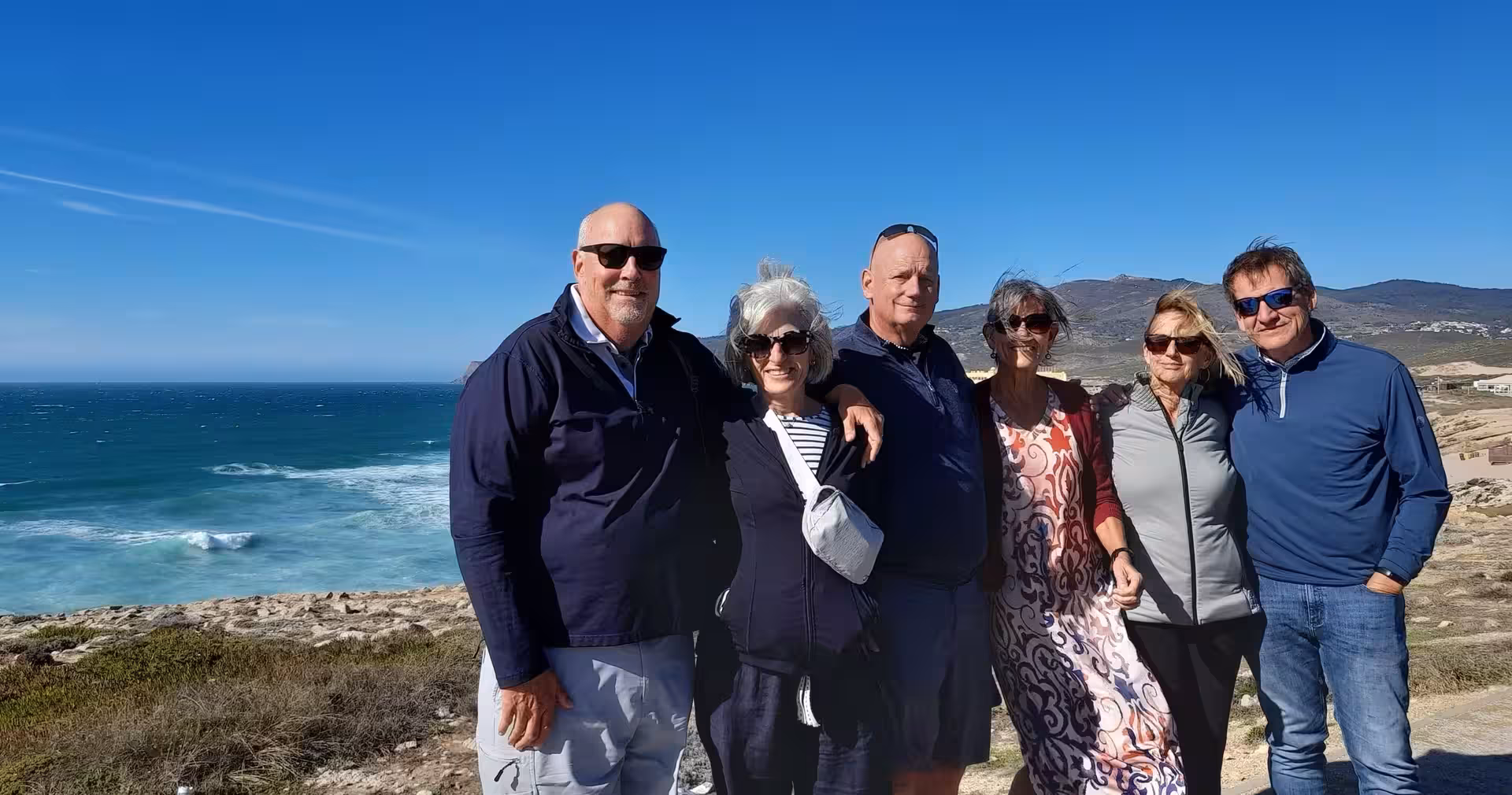 Travelers at Cabo da Roca cliffs on 7-day Portugal tour from Lisbon to Porto, Atlantic coast views