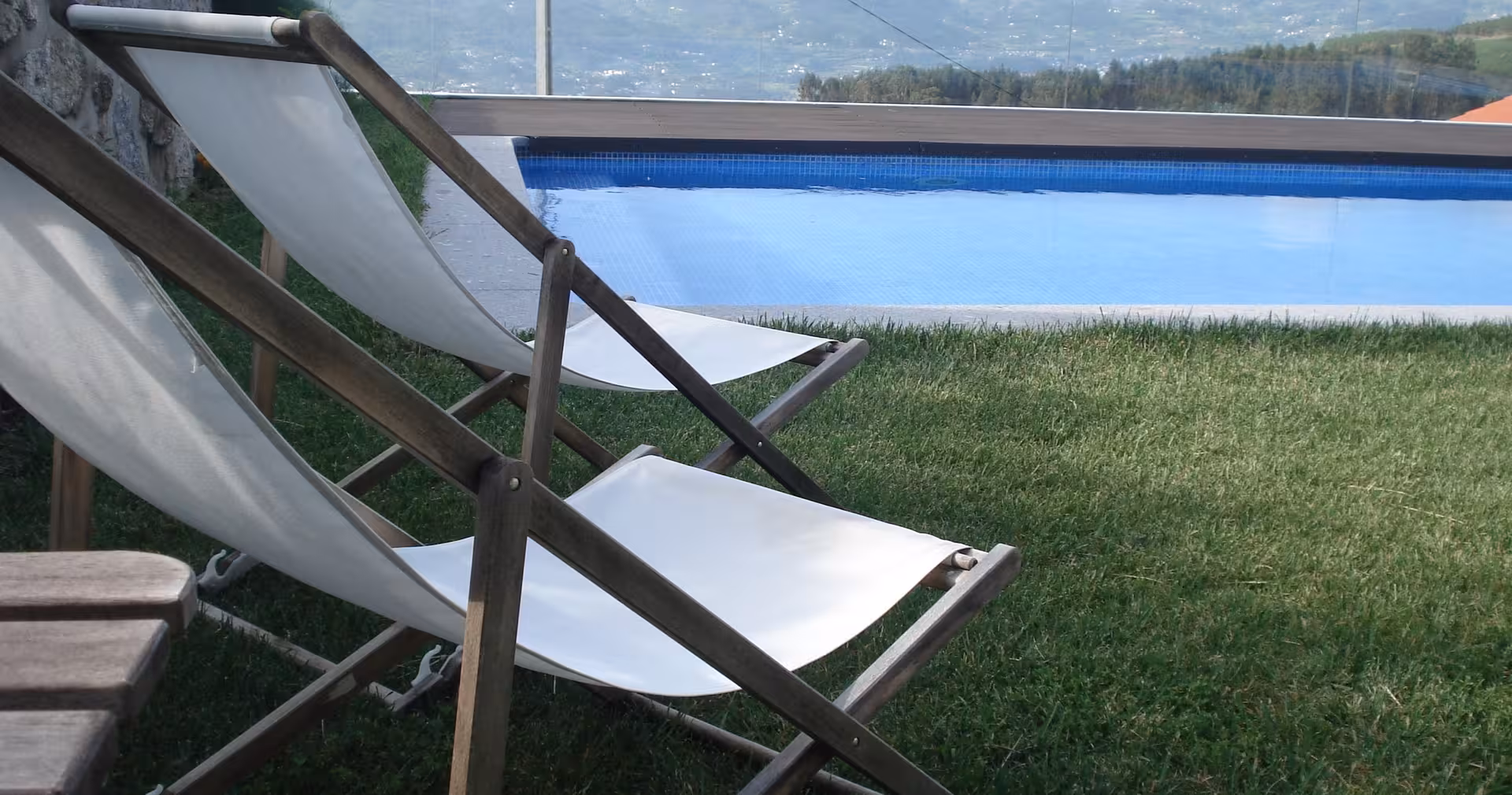 Poolside lounge chairs at a Portugal countryside hotel, relaxing stop on 8-day food and wine tour