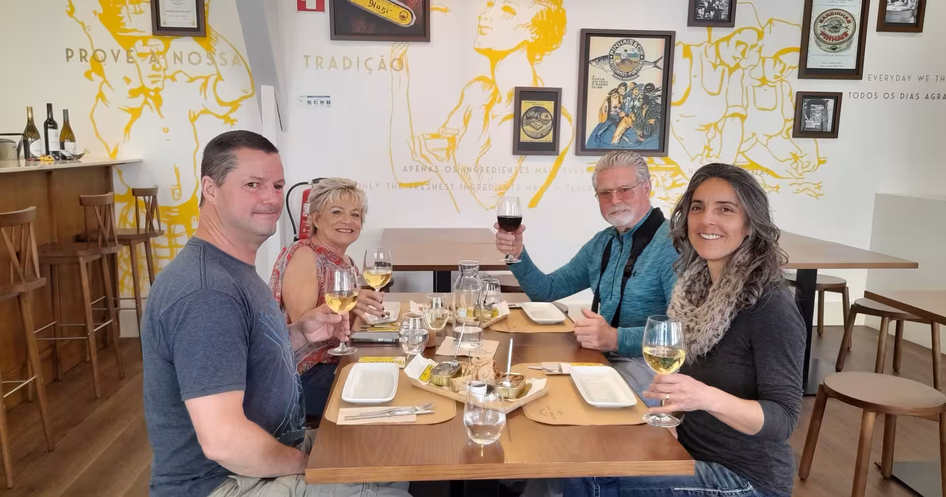 Tour guests toast Portuguese wines at a Lisbon restaurant on an 8-day Portugal food and wine tour