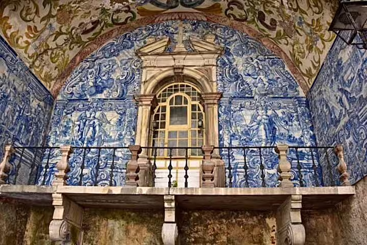 Intricate blue azulejos decorate a historic building facade, showcasing Portuguese artistry on the Fatima Nazare Obidos tour from Lisbon.