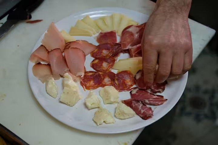 A platter of traditional Portuguese charcuterie and cheeses being prepared for Porto's Secret Traditional Flavours tour.