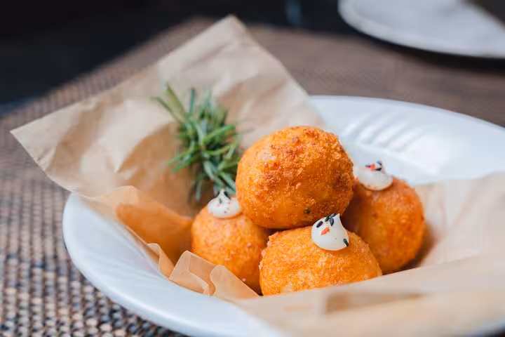 Delicious Portuguese croquettes served with rosemary on a Lisbon food tour.