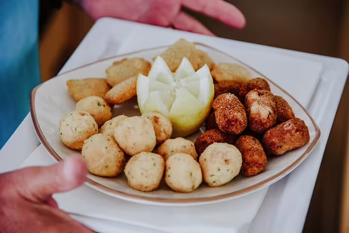 A delicious assortment of traditional Portuguese snacks served on a luxury catamaran during a half-day tour on Madeira Island.