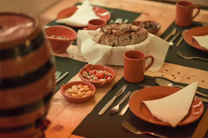 Traditional Portuguese dinner setup with rustic dishes and bread, perfect for a Fado show evening in Lisbon.
