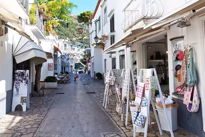 Charming alleyway in Positano lined with shops and vibrant facades, showcasing the quaint beauty of the Amalfi Coast.