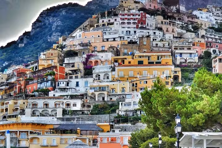 Colorful hillside town of Positano viewed from the sea, featuring vibrant architecture and lush greenery on the Amalfi Coast.