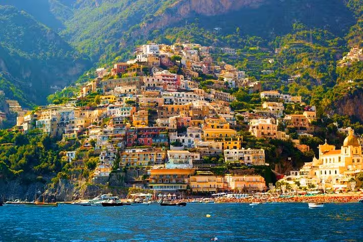Vibrant Positano perched on lush cliffs above the blue waters of the Amalfi Coast, offering breathtaking scenery.