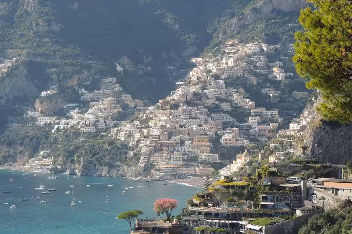 Panoramic view of Positano's charming cliffside village and turquoise waters on the Amalfi Coast.