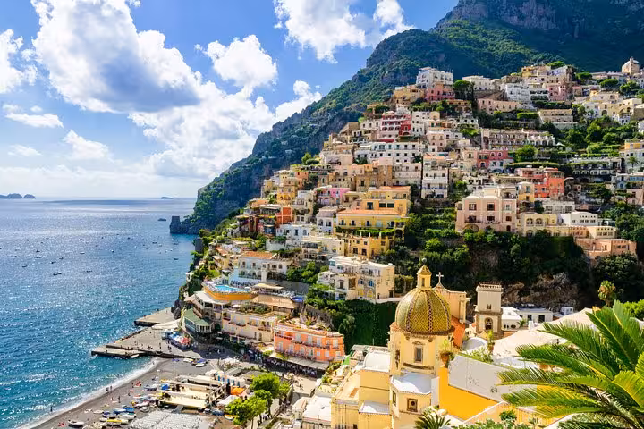 Panoramic view of Positano's vibrant hillside buildings cascading down to the picturesque Amalfi coastline.