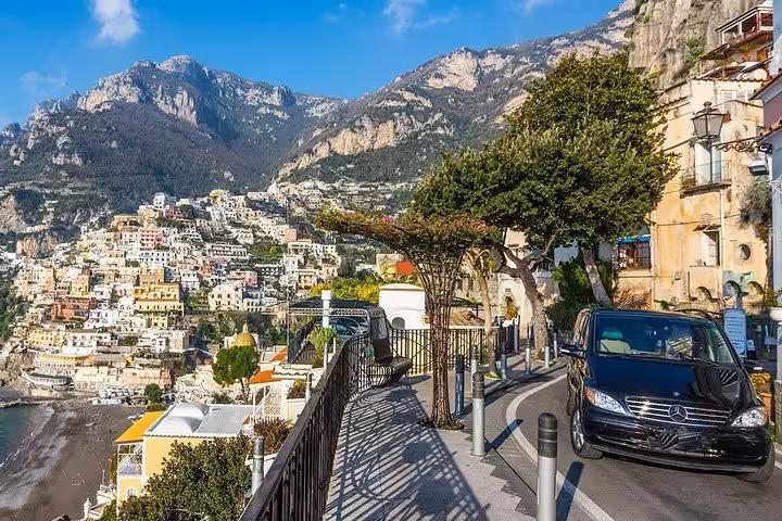 Scenic view of Positano's colorful cliffside buildings from a minivan on the Amalfi Coast tour from Sorrento.